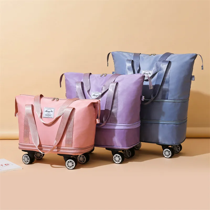 Pink, purple and blue-grey expandable wheeled duffle bags shown at different heights